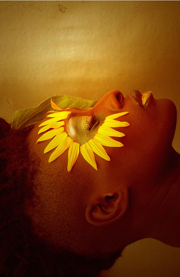 Bathed in molten gold tones, the portrait carries the emotional richness of a luxury beauty campaign while maintaining the raw intimacy of fine art photography. The skin glows like bronze sculpture under late summer light.